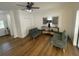 Gathering room with wood-look floors, sliding glass doors, and comfy seating at 7408 Oak Run Ln, Sarasota, FL 34243