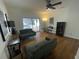 Gathering room with wood-look floors, sliding glass doors to the pool, and comfy seating at 7408 Oak Run Ln, Sarasota, FL 34243