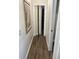 Hallway with mirrored closet doors and hardwood floors at 7408 Oak Run Ln, Sarasota, FL 34243