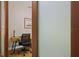 Home office features a desk, chair, and frosted glass door at 7408 Oak Run Ln, Sarasota, FL 34243