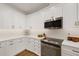 Bright kitchen featuring white cabinets, stainless steel appliances, and quartz countertops at 7408 Oak Run Ln, Sarasota, FL 34243