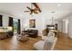 Open living room with hardwood floors, a fireplace, and access to the backyard at 7408 Oak Run Ln, Sarasota, FL 34243