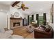 Spacious living room with a fireplace, hardwood floors, and a view of the backyard pool at 7408 Oak Run Ln, Sarasota, FL 34243