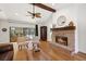 Comfortable living room with fireplace, hardwood floors, and sliding doors to patio at 7408 Oak Run Ln, Sarasota, FL 34243