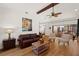 Relaxing living room with hardwood floors, a fireplace, and access to the pool at 7408 Oak Run Ln, Sarasota, FL 34243
