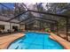 Relaxing screened pool and patio; features a swim-up bench at 7408 Oak Run Ln, Sarasota, FL 34243