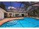 Lush backyard oasis with a screened pool and spacious patio at 7408 Oak Run Ln, Sarasota, FL 34243
