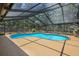 Inviting screened pool area with a kidney-shaped pool and ample deck space at 7408 Oak Run Ln, Sarasota, FL 34243