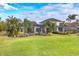 Luxury home with a large backyard, pool, and tropical landscaping at 7504 Windy Hill Cv, Lakewood Ranch, FL 34202