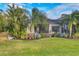 Landscaped backyard with tropical plants and large pool area at 7504 Windy Hill Cv, Lakewood Ranch, FL 34202