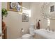 Charming half-bathroom with pedestal sink and decorative mirror at 7504 Windy Hill Cv, Lakewood Ranch, FL 34202