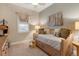 Cozy bedroom featuring a daybed, decorative pillows and natural light at 7504 Windy Hill Cv, Lakewood Ranch, FL 34202