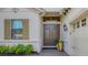 Front entry with double doors and landscaping at 7504 Windy Hill Cv, Lakewood Ranch, FL 34202