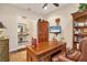 Spacious home office features a large desk, built-in shelving, and hardwood floors at 7504 Windy Hill Cv, Lakewood Ranch, FL 34202