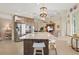 Spacious kitchen features a large island with seating, stainless steel appliances, and granite countertops at 7504 Windy Hill Cv, Lakewood Ranch, FL 34202