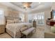 Bright and airy main bedroom with a king-size bed, and large windows at 7504 Windy Hill Cv, Lakewood Ranch, FL 34202