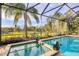 Inviting pool and spa with a lush, tropical backdrop at 7504 Windy Hill Cv, Lakewood Ranch, FL 34202