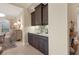 Convenient wet bar with cabinetry, sink, and granite countertop at 7504 Windy Hill Cv, Lakewood Ranch, FL 34202