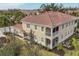 Back view of building highlighting the screened patio and landscaping at 8150 Enclave Way # 104, Sarasota, FL 34243