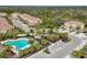 Community pool and surrounding buildings with lush landscaping at 8150 Enclave Way # 104, Sarasota, FL 34243