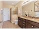 Double vanity bathroom with granite countertops and a large walk-in shower at 8150 Enclave Way # 104, Sarasota, FL 34243