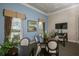 Community room with tables and chairs, ideal for gatherings at 8150 Enclave Way # 104, Sarasota, FL 34243