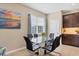 Glass dining table with black chairs in the kitchen area at 8150 Enclave Way # 104, Sarasota, FL 34243