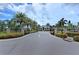 Gated community entrance with landscaping at 8150 Enclave Way # 104, Sarasota, FL 34243