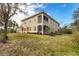 Side view of building showcasing a screened patio and lush lawn at 8150 Enclave Way # 104, Sarasota, FL 34243