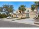 Three-unit building with attached garages, palm trees, and a residential street at 8150 Enclave Way # 104, Sarasota, FL 34243