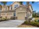 Tan two-story condo building with attached garage and landscaping at 8150 Enclave Way # 104, Sarasota, FL 34243
