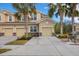 Front view of three-unit building with attached garages and landscaping at 8150 Enclave Way # 104, Sarasota, FL 34243