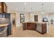 Modern kitchen island with granite countertop and stainless steel dishwasher at 8150 Enclave Way # 104, Sarasota, FL 34243