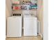 Laundry room with washer, dryer, and shelving at 8150 Enclave Way # 104, Sarasota, FL 34243