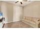 Small living room with striped couch and tv at 8150 Enclave Way # 104, Sarasota, FL 34243
