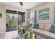 Living area showcasing a comfy sofa, glass coffee table, and view of a screened balcony at 8150 Enclave Way # 104, Sarasota, FL 34243