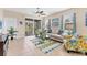 Bright living room with tile floors, comfy seating, and access to a screened balcony at 8150 Enclave Way # 104, Sarasota, FL 34243