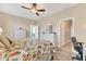 Bright main bedroom with king bed, dresser, and access to en-suite bathroom at 8150 Enclave Way # 104, Sarasota, FL 34243