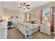 Spacious main bedroom with a king-size bed, built-in desk, and neutral decor at 8150 Enclave Way # 104, Sarasota, FL 34243