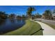Community pond with fountain and walkway at 8150 Enclave Way # 104, Sarasota, FL 34243
