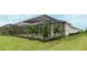 Landscaped backyard with a screened-in patio and pool area, surrounded by well-manicured lawn and lush shrubbery at 8376 Sea Glass Ct, Sarasota, FL 34240