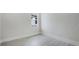A minimalist bedroom design with wood-look tile floors and a double window with a white trim at 8376 Sea Glass Ct, Sarasota, FL 34240