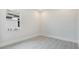 A minimalist bedroom design with wood-look tile floors and a double window with a white trim at 8376 Sea Glass Ct, Sarasota, FL 34240