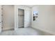 A minimalist bedroom design with closet and wood-look tile floors, window with natural light at 8376 Sea Glass Ct, Sarasota, FL 34240