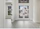 Entryway showcasing a glass-paneled front door, light gray floors, and an open floor plan at 8376 Sea Glass Ct, Sarasota, FL 34240