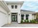 Home featuring manicured landscaping, a paved driveway, and a dark-colored glass paneled front door at 8376 Sea Glass Ct, Sarasota, FL 34240