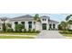 Charming home showcasing manicured landscaping, a paved driveway, and a two-car garage at 8376 Sea Glass Ct, Sarasota, FL 34240