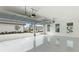 View of the bright garage with epoxy floors and carriage door, revealing the paver driveway and neighborhood at 8376 Sea Glass Ct, Sarasota, FL 34240