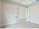 Bright home office with light gray floors, white walls, and glass paneled doors at 8376 Sea Glass Ct, Sarasota, FL 34240