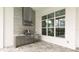 This outdoor kitchen features a stainless steel BBQ, sink and mini-refrigerator at 8376 Sea Glass Ct, Sarasota, FL 34240